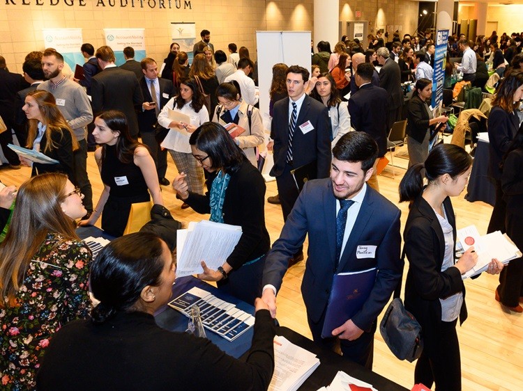 Large crowd of people in business attire attending an event