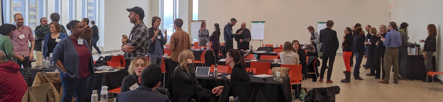 Groups of people in conversation at a communication workshop.